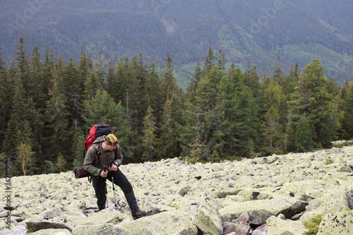 Active healthy man hiking in beautiful forest