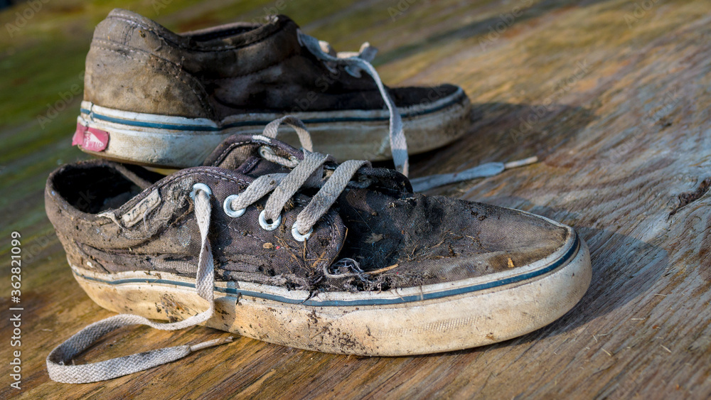 London, England - May 23, 2014: Well worn pair Vans skateboarding trainers, Vans is based in Santa Ana, California and founded in 1966 Stock Photo | Adobe Stock