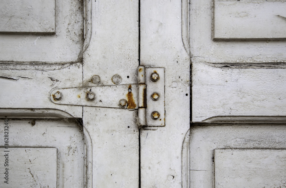 Old rusty hinge on a wooden window Old rusty hinge on a wooden window