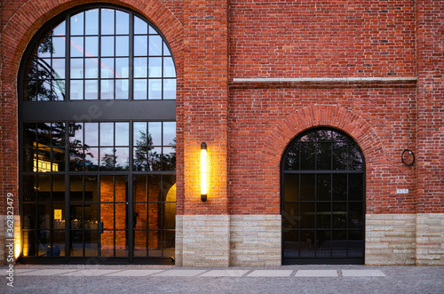 Brick architecture in European style with a large loft style window and lighting