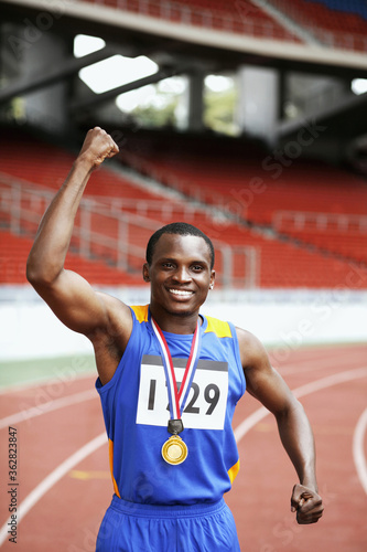 Man with gold medal celebrating his success