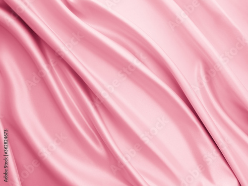 Beautiful smooth elegant wavy light pink satin silk luxury cloth fabric texture, abstract background design. Copy space