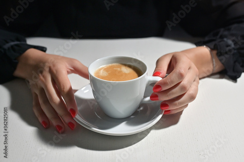 Young Woman with Coffee and Red Nail Polish