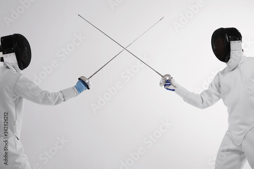 Two men in fencing suits in a duel