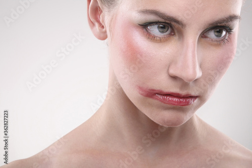 Фотография Close-up of a woman's face with make-up and smudged lipstick