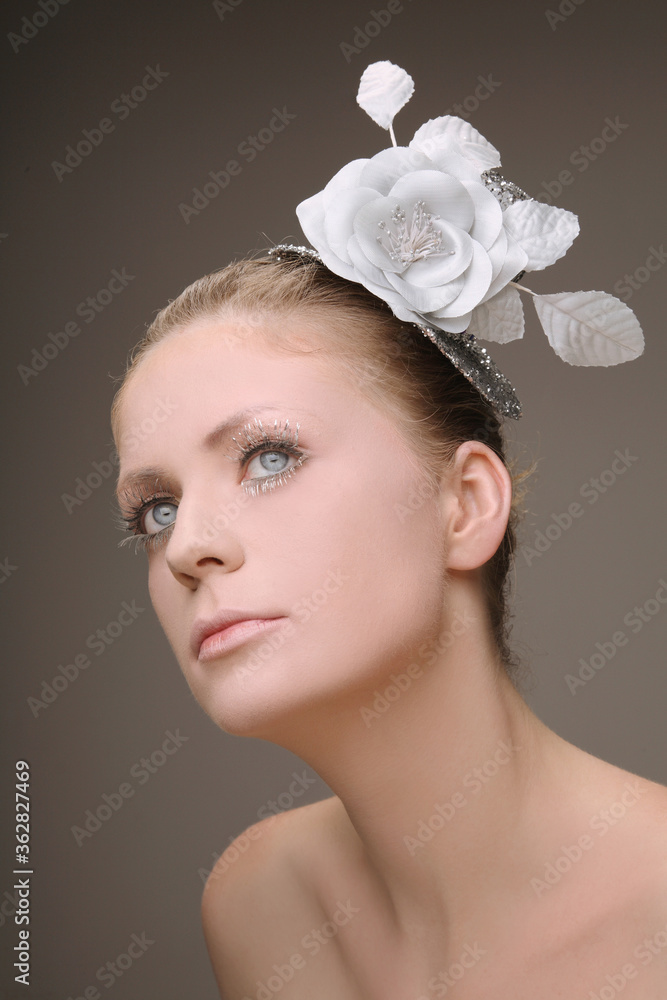 Woman with flower and hat decorating her hair Woman with flower and hat decorating her hair