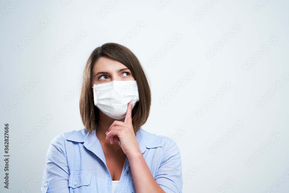 Attractive woman wearing protective mask isolated over white background Attractive woman wearing protective mask isolated over white background