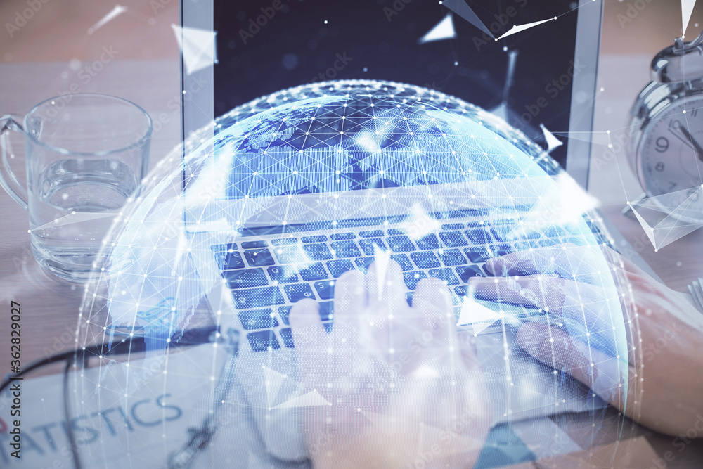 Multi exposure of businessman working on laptop on background. International business hologram in front. Concept of success. Multi exposure of businessman working on laptop on background. International business hologram in front. Concept of success.