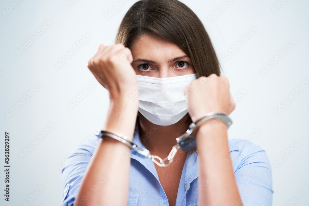 Attractive woman wearing protective mask isolated over white background