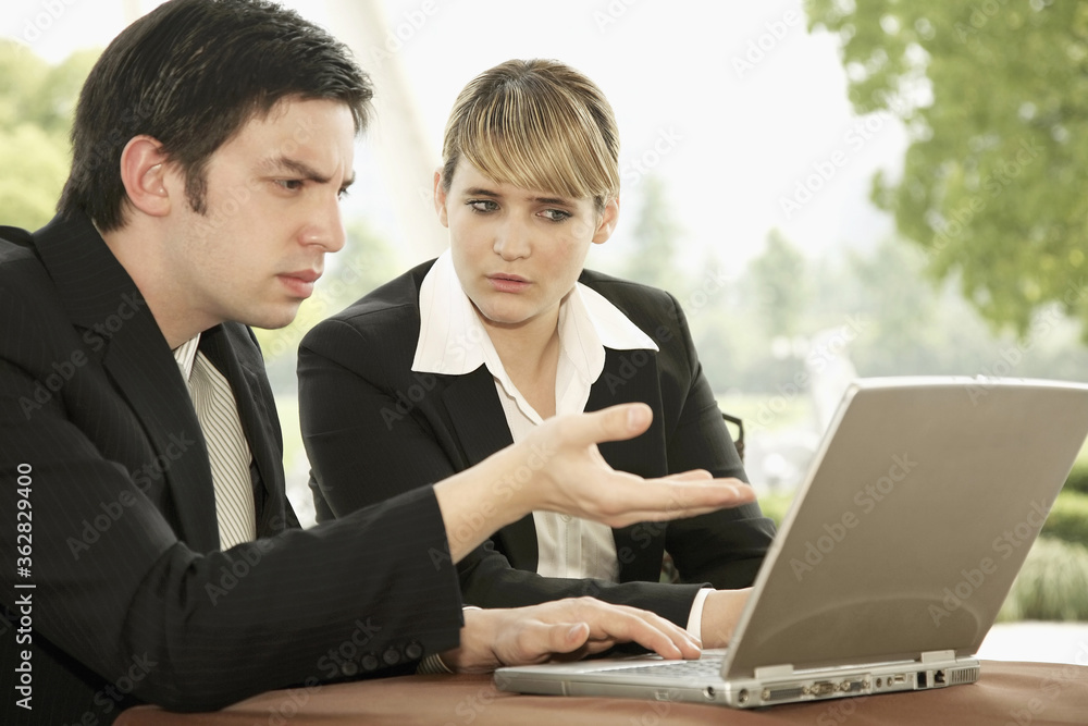 Business people having discussion while using laptop Business people having discussion while using laptop