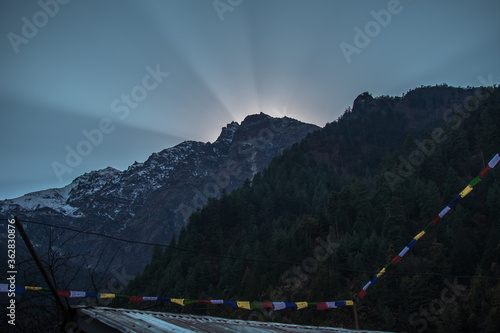 Bright sun rays peaking over the nepalese mountain tops, Annapurna circuit, Nepal