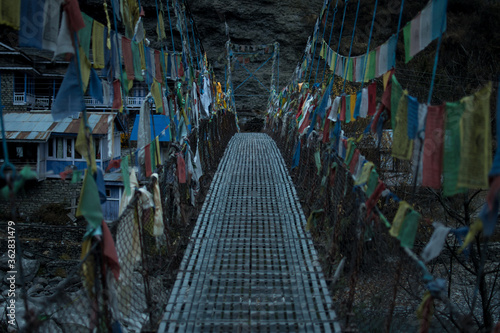 Chame suspension bridge colorful buddhist prayer flags, Annapurna circuit, Nepal © Arvid Norberg