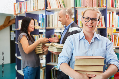 Woman as a bookseller with a stack of books