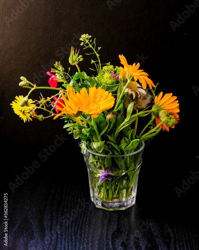 Fototapeta Naklejka Na Ścianę i Meble -  Ramo de flores silvestres en un vaso de agua