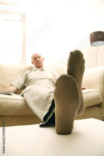 Senior man resting on couch