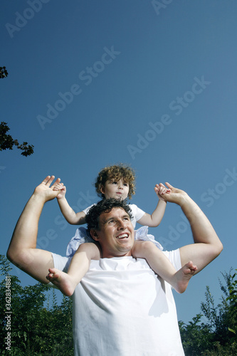 Father with daughter on his shoulder