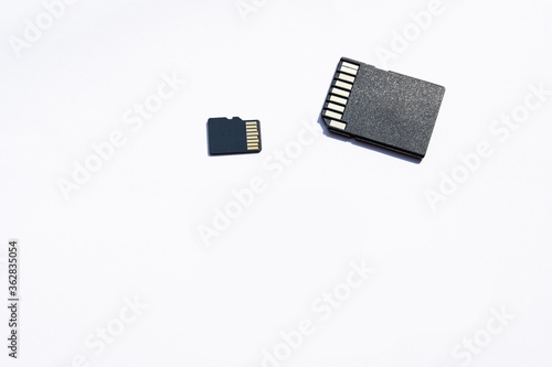 a couple of black sd and micro sd memory cards on the white background. selective focus