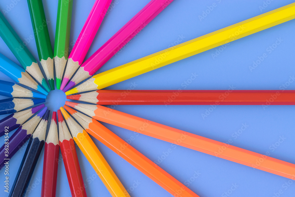 Fototapeta premium Colored pencils are laid out with rainbow colors. Goods for study and development. Art.