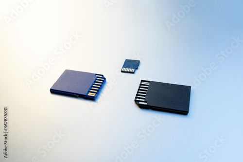 Three micro memory cards on gray background. Memory cards for digital files, close up