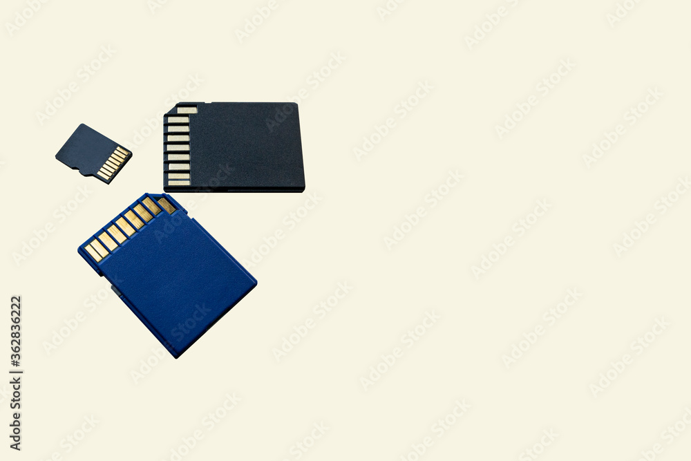 Close-up three memory cards lie on a beige surface. Media storage concept. Memory for gadgets and devices, copy space for text. Close-up three memory cards lie on a beige surface. Media storage concept. Memory for gadgets and devices, copy space for text.