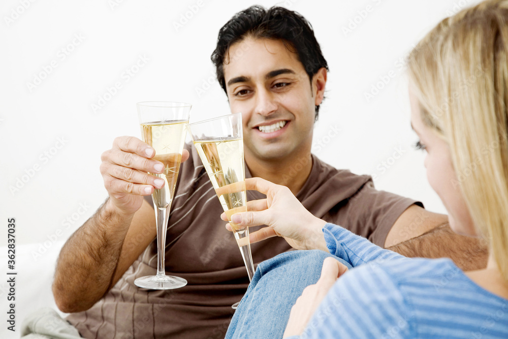 Couple toasting drinks in their new house Couple toasting drinks in their new house