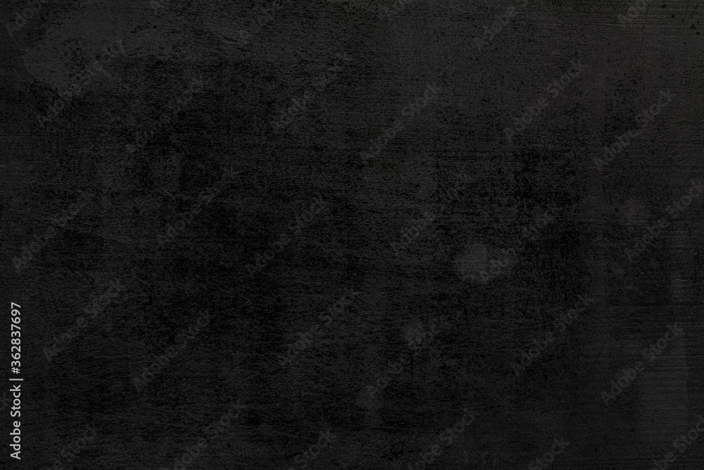 a black background of old, weathering rough texture. a black background of old, weathering rough texture.