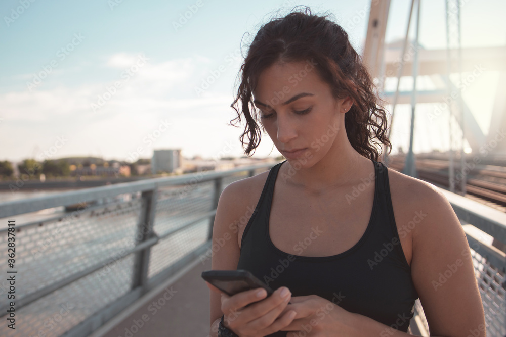 Fitness woman using smart phone	
