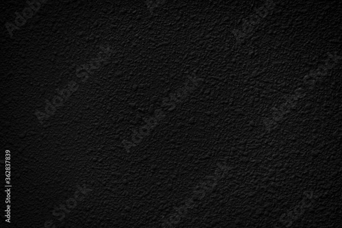 a black background with a rough, irregular texture.