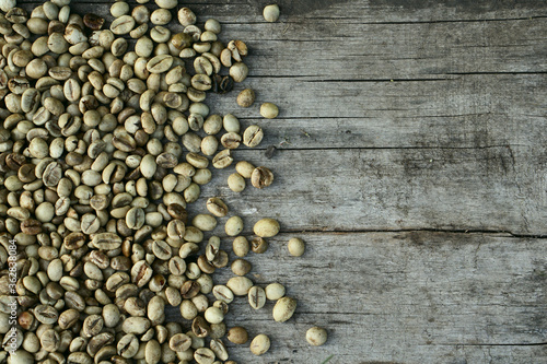 Background of green coffee beans on rustic wooden