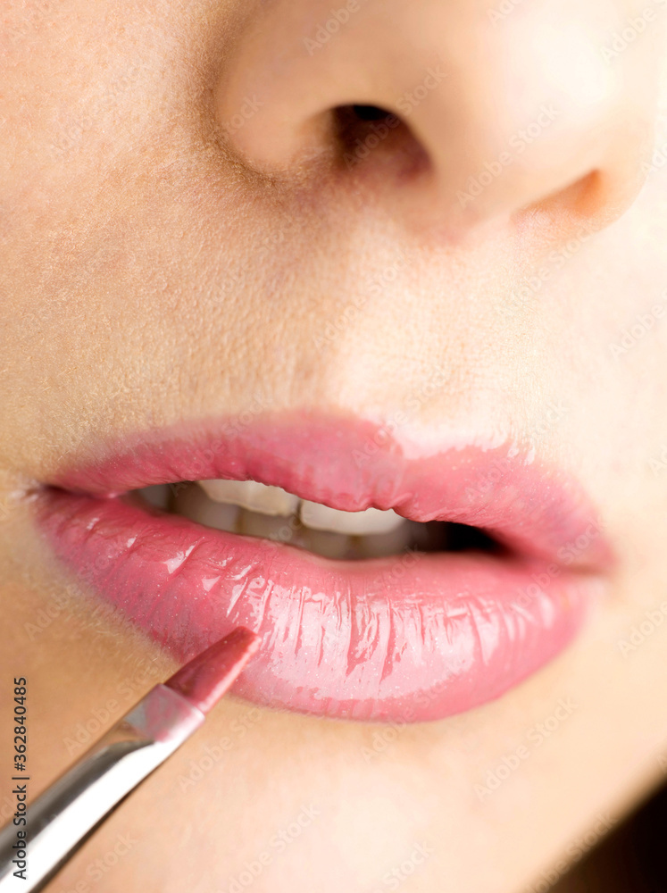 Naklejka premium Applying lip colour