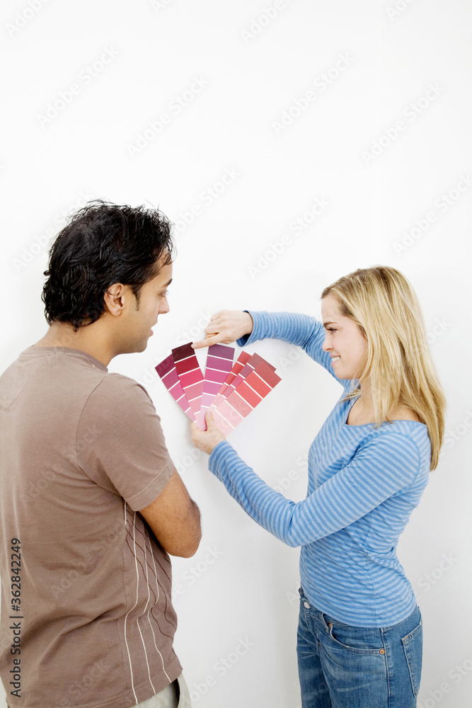 Couple choosing suitable colour from the colour chart Couple choosing suitable colour from the colour chart