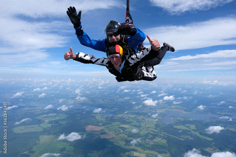 Skydiving. Tandem jump. Two guys are flying in the sky.