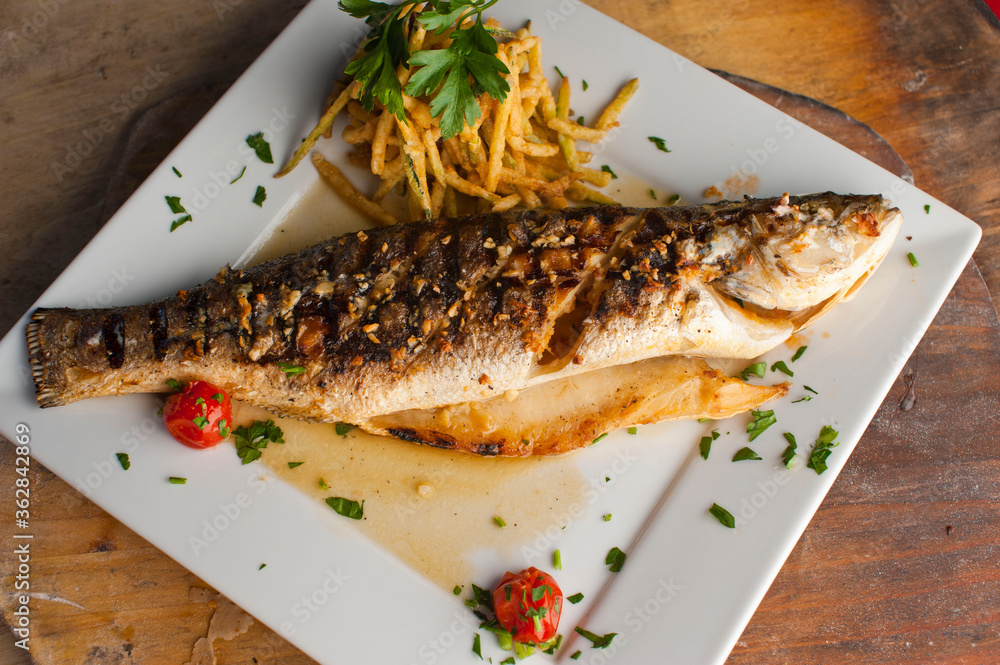 Branzino, whole grilled sea bream. Classic ethnic regional Greek