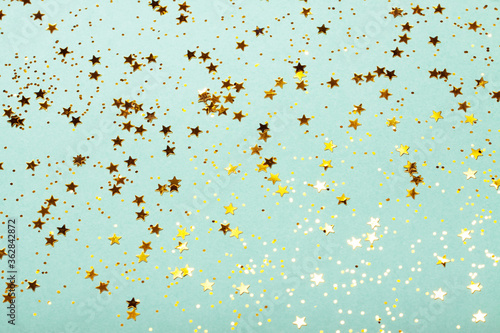Trendy mint background with golden stars. The concept of celebrations, the Day of St. Valentine, Christmas, New Year, holiday, birthday, etc.