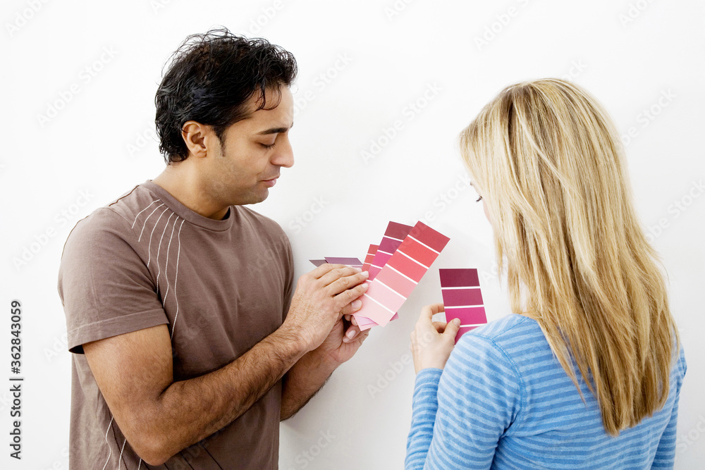 Couple choosing suitable colour from the colour chart Couple choosing suitable colour from the colour chart