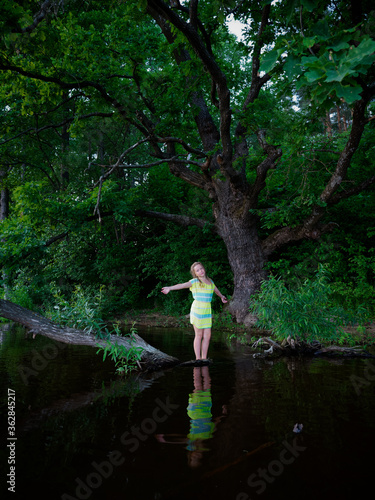 girl by the old oak tree by the lake