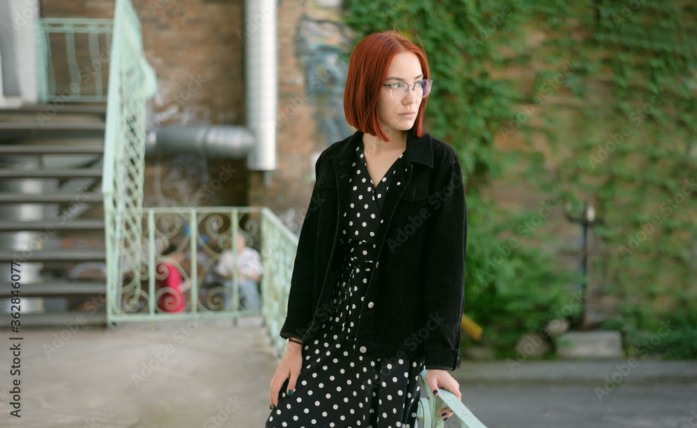 Fototapeta premium Portrait of beautiful redhead woman wearing glasses.