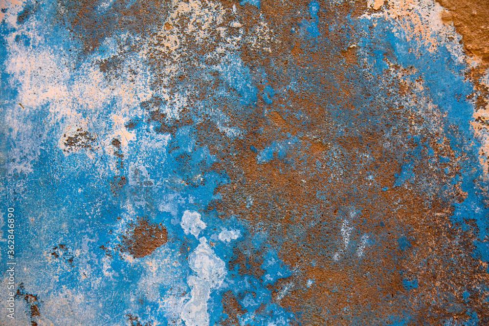 Blue texture wall with broken plaster. Details of damaged wall with pealing paint due to wall damp and mold. Blue texture wall with broken plaster. Details of damaged wall with pealing paint due to wall damp and mold.