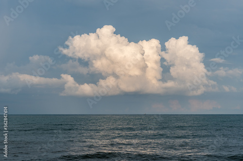 Calm Sea, Black Sea and white clouds on a Blue Sky Background