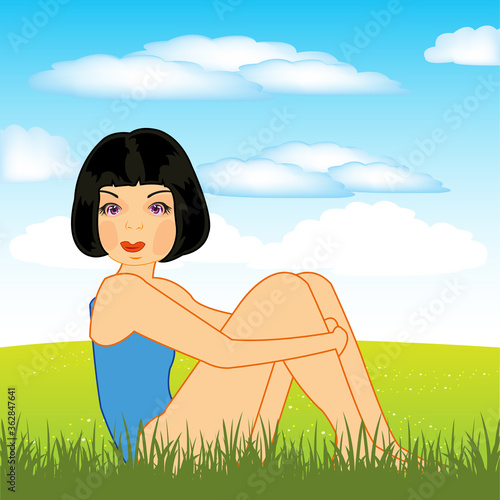 Beautiful girl sits on green year glade