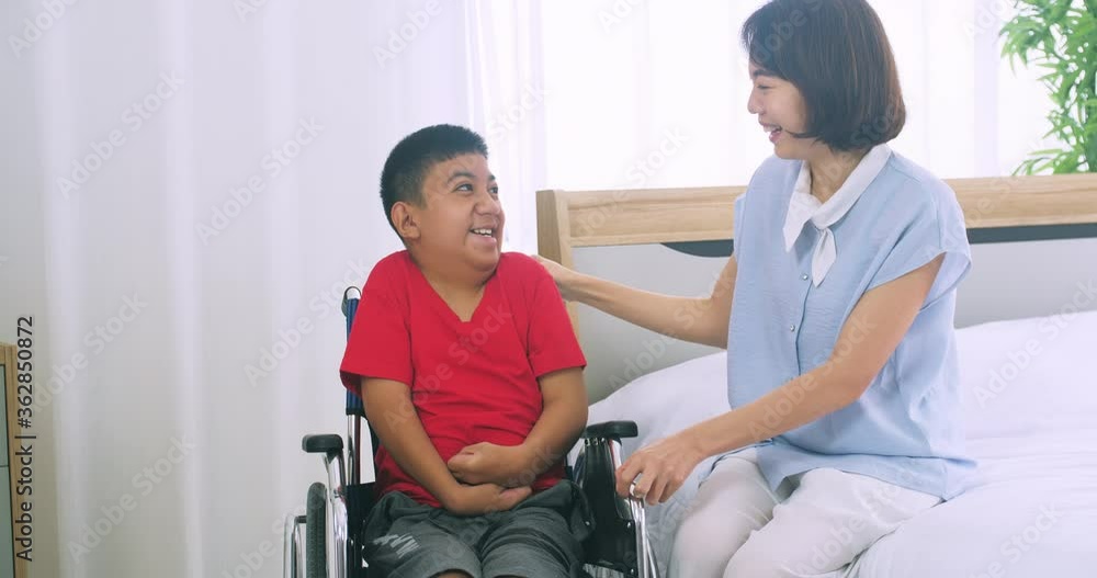 Happy family with mother and disabled son spending time together at home. Happy family with mother and disabled son spending time together at home.