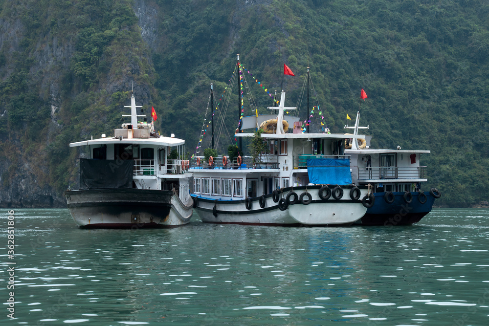 Ha Long Bay Vietnam, group of tourist cruise boats moored on harbour