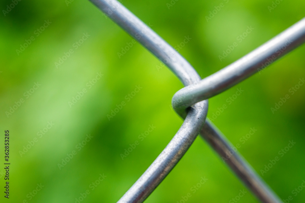 A piece of metal mesh fence closeup A piece of metal mesh fence closeup