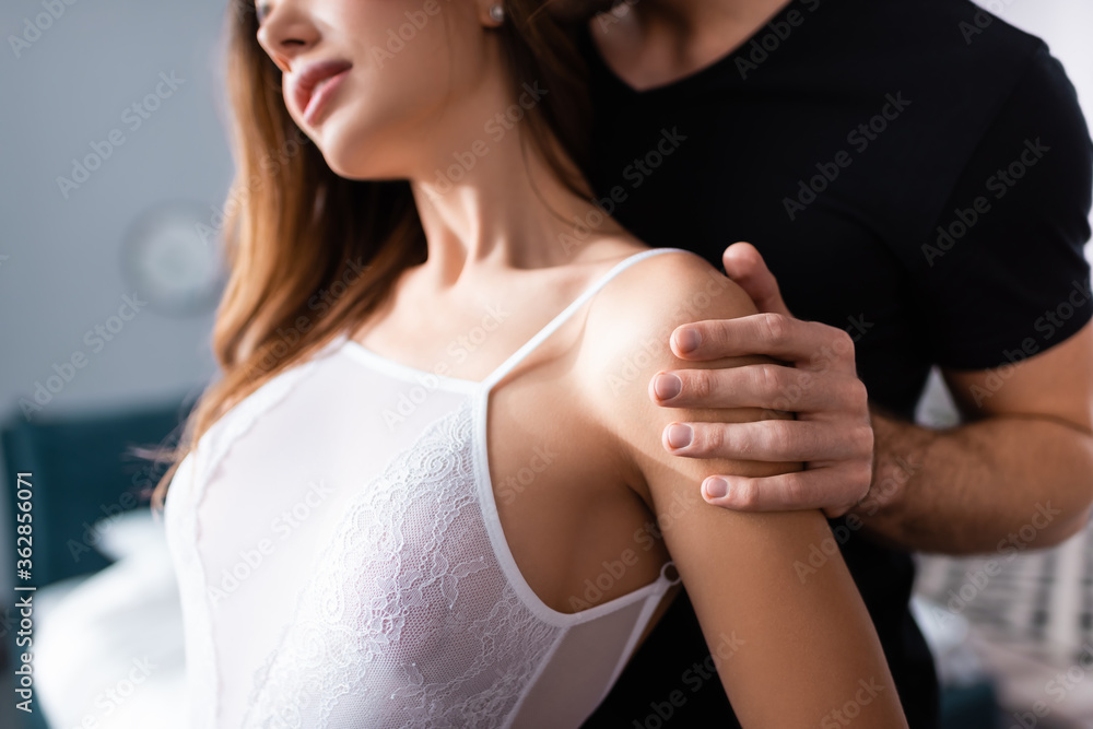 Cropped view of man embracing sexy woman at home Cropped view of man embracing sexy woman at home