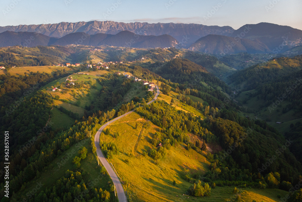 Aerial landscape of beautiful green hills in Transylvania, at the feet of the Carpathians