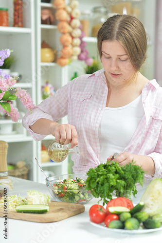 Portrait of teen girl preparing fresh salad