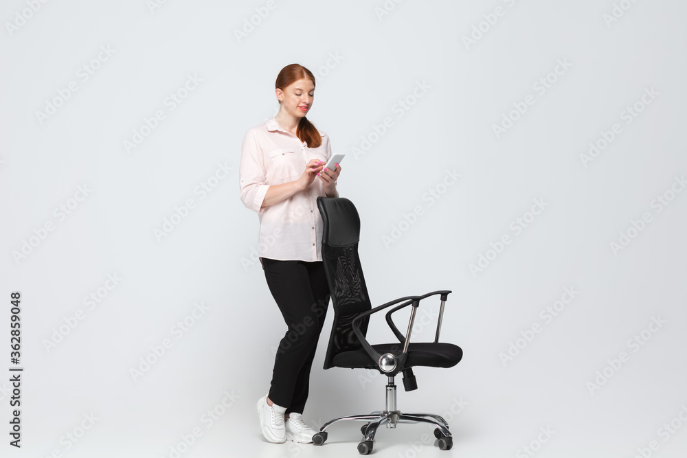Chatting, working. Young woman in casual wear on white background. Bodypositive character, feminism, loving herself, beauty concept. Plus size businesswoman during paperwork. Inclusion, diversity. Chatting, working. Young woman in casual wear on white background. Bodypositive character, feminism, loving herself, beauty concept. Plus size businesswoman during paperwork. Inclusion, diversity.