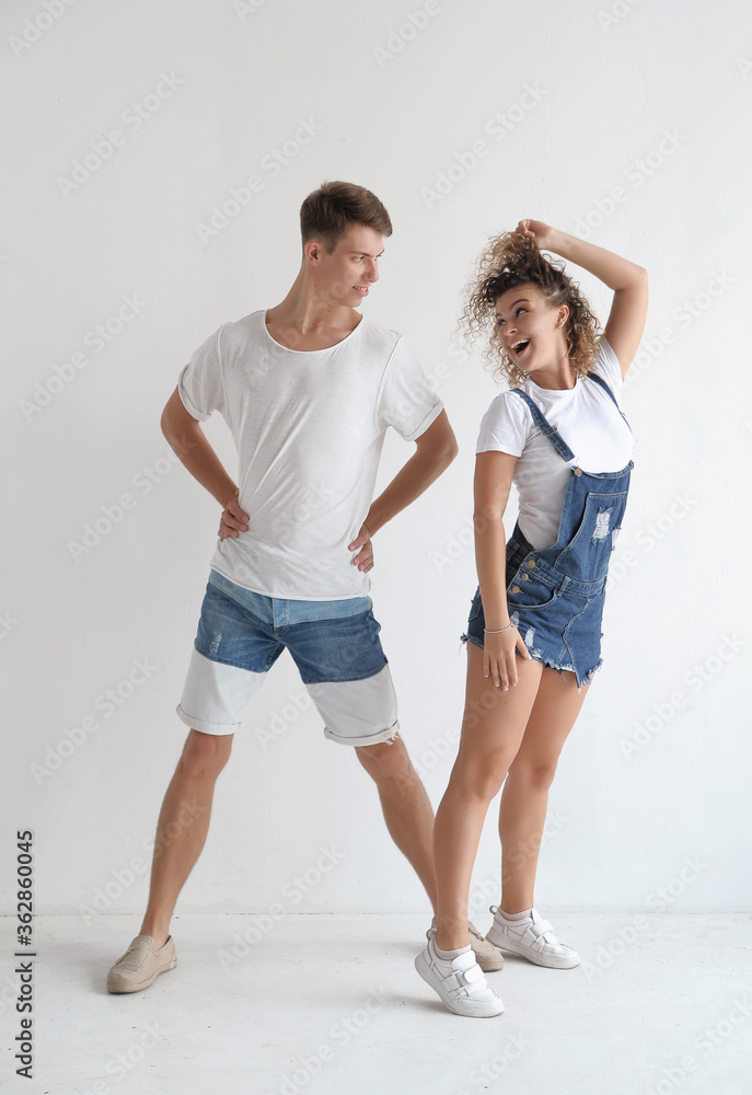 Beautiful couple in stylish dark costumes dancing ballroom dances