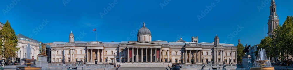 Panorama of the facade of the building of the National Gallery museum, one of the most important cultural sightseeing spot of London on a sunny day.