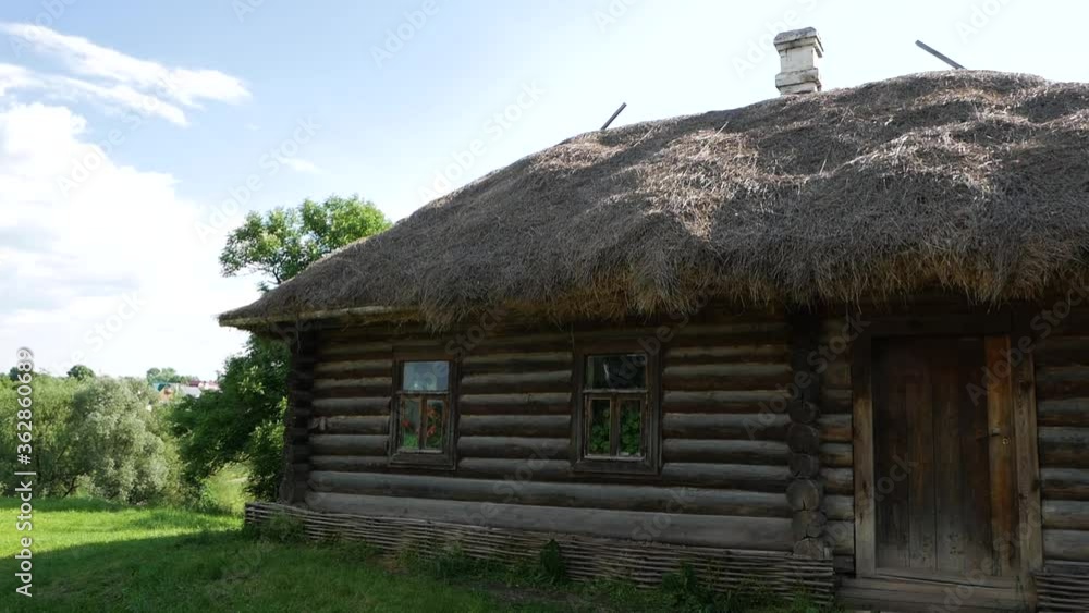 The old wooden house in village inhabited by old people and the yard was overgrown with grass and the thatched roof is leaky The old wooden house in village inhabited by old people and the yard was overgrown with grass and the thatched roof is leaky